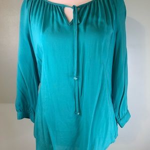 Turquoise blouse with keyhole design. Beaded tie strings.